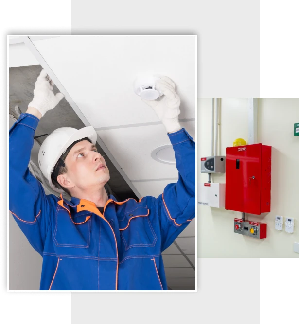 Man in hard hat adjusting fire alarm