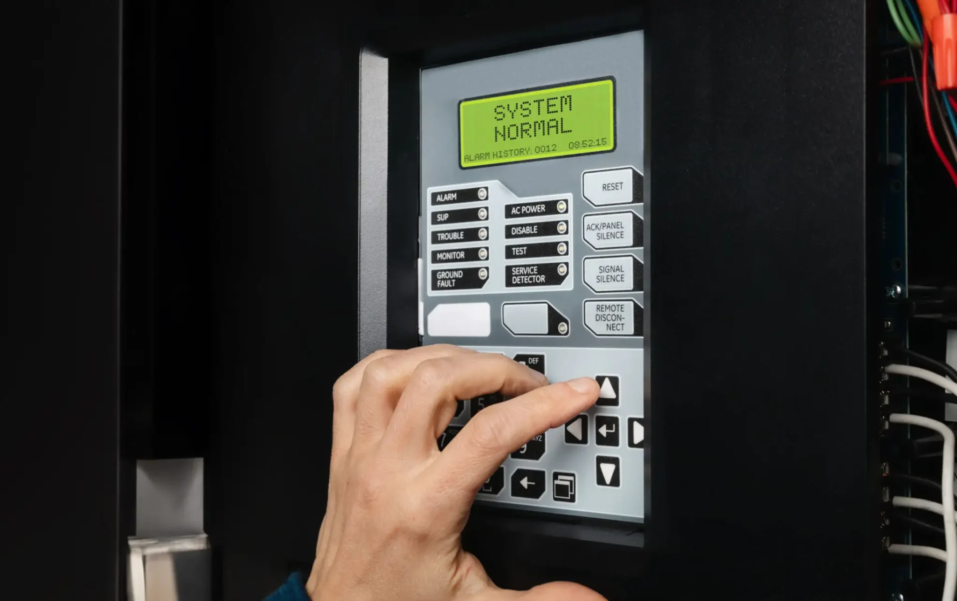 Hand inputting code on a security keypad.